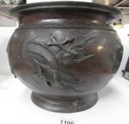 A 19th century bronze jardiniere featuring dragons and decoration to base,