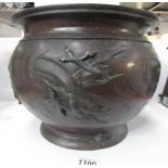 A 19th century bronze jardiniere featuring dragons and decoration to base,