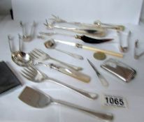A mixed lot of silver plate cutlery including several sugar tongs