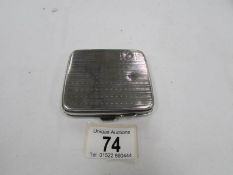 A silver cigarette case,