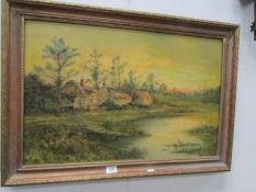 An oil on board cottage scene signed G Cole