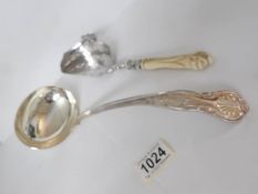 An ornate silver plated crumb scoop and a silver plate ladle
