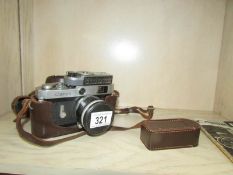 A Canon Populaire camera in case with light meter
