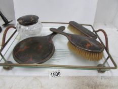 A silver and tortoise shell dressing table set on tray