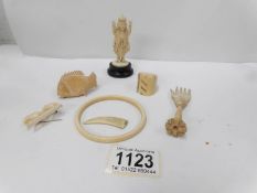 A quantity of ivory items including 4 faced figure and a hand