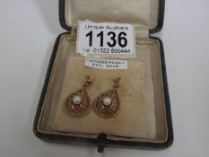 A pair of 9ct gold pendant earrings set pearls