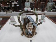 A continental porcelain candelabra depicting a shoe mender