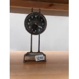 An unusual metal cased mantel clock