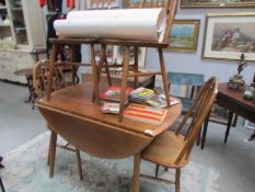 An Ercol style table and 4 chairs