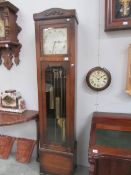 An oak cased triple weight long case clock