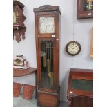 An oak cased triple weight long case clock