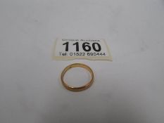 A 22ct gold wedding band, size L,