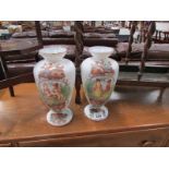 A pair of hand painted opaque glass vases
