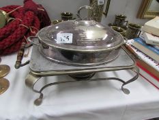 A silver plated breakfast dish complete with burner