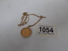 A 1964 half sovereign in 9ct gold mount on chain