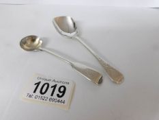 A silver caddy spoon and a small silver ladle,