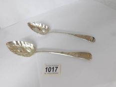 A pair of embossed silver serving spoons, maker R B W B.