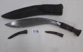 A Kukri in sheath and complete with skinning knives