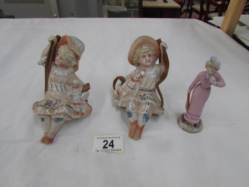 A pair of Victorian mantelpiece figures and one other