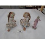 A pair of Victorian mantelpiece figures and one other