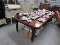 An extending mahogany dining table