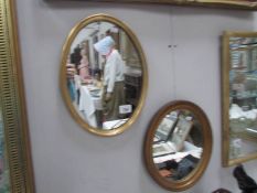 2 small oval gilt framed mirrors