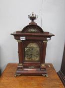 A German oak cased clock with key and pendulum (2 finials missing)