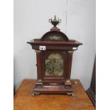 A German oak cased clock with key and pendulum (2 finials missing)