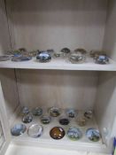 A collection of 33 glass paperweights of various tourist places
