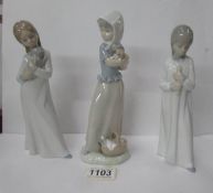 3 NAO figurines of girls holding animals