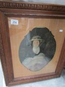 An oak framed picture of a lady