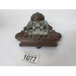 A 1920's cast metal inkstand with glass inkwell