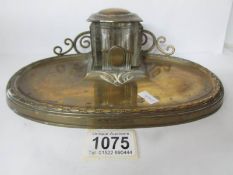 A 19th century brass ink stand with scroll back gallery