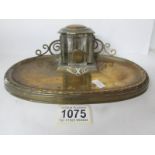 A 19th century brass ink stand with scroll back gallery