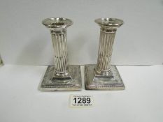 A pair of silver candlesticks, maker M & W,