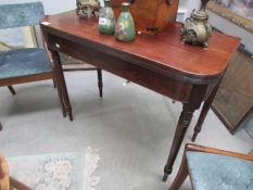 A mahogany fold over table