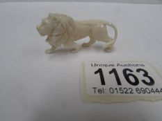 A good small European carved ivory lion,