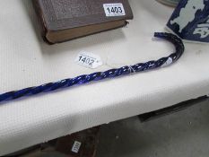 A long blue glass barley twist walking cane