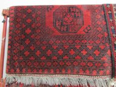 A red patterned Arabian rug