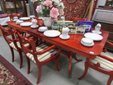 A mahogany extending table and set of 6 brass inlaid chairs