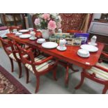 A mahogany extending table and set of 6 brass inlaid chairs