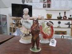 2 female figures and a bear