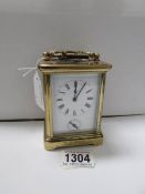 A French brass carriage clock with key and alarm