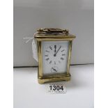 A French brass carriage clock with key and alarm