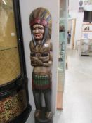 A carved wood figure of a native American Indian