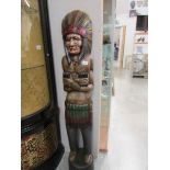 A carved wood figure of a native American Indian