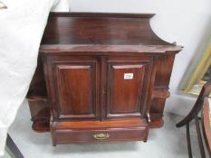 A mahogany wall cabinet