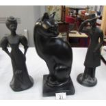 A cat figure and a pair of lady and gentleman figures