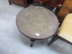 A circular brass topped Indian table