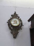 An ornate wall clock with pendulum